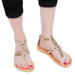 Women's thong sandals with handmade crossed laces in gold laminated calfskin